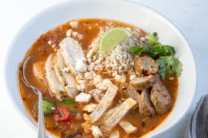 Tortilla soup with garnishes, in a bowl
