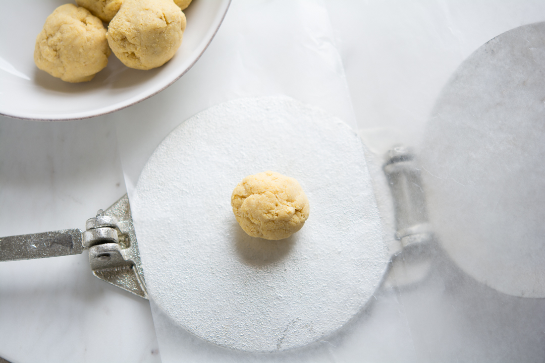 Ball of tortilla dough on the tortilla press