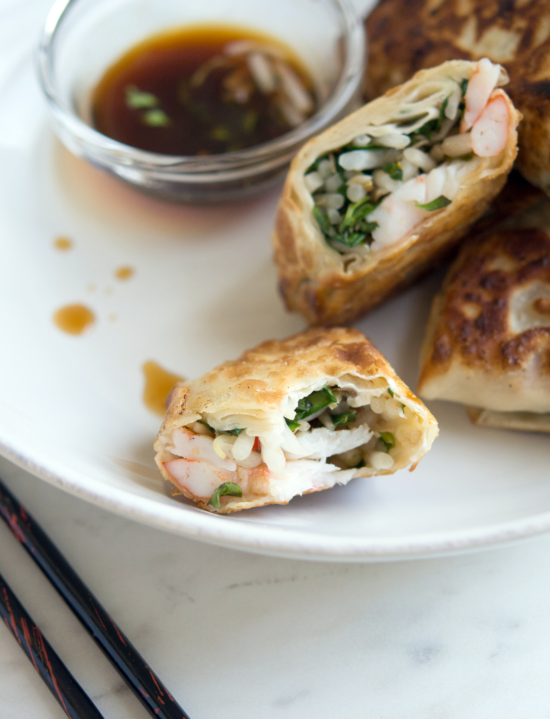 Pan-Fried Shrimp Egg Rolls with a bite taken out of it