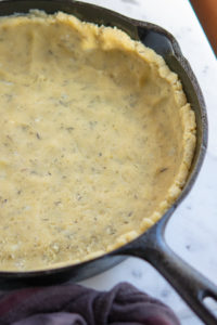 almond crust dough in a cast iron pan