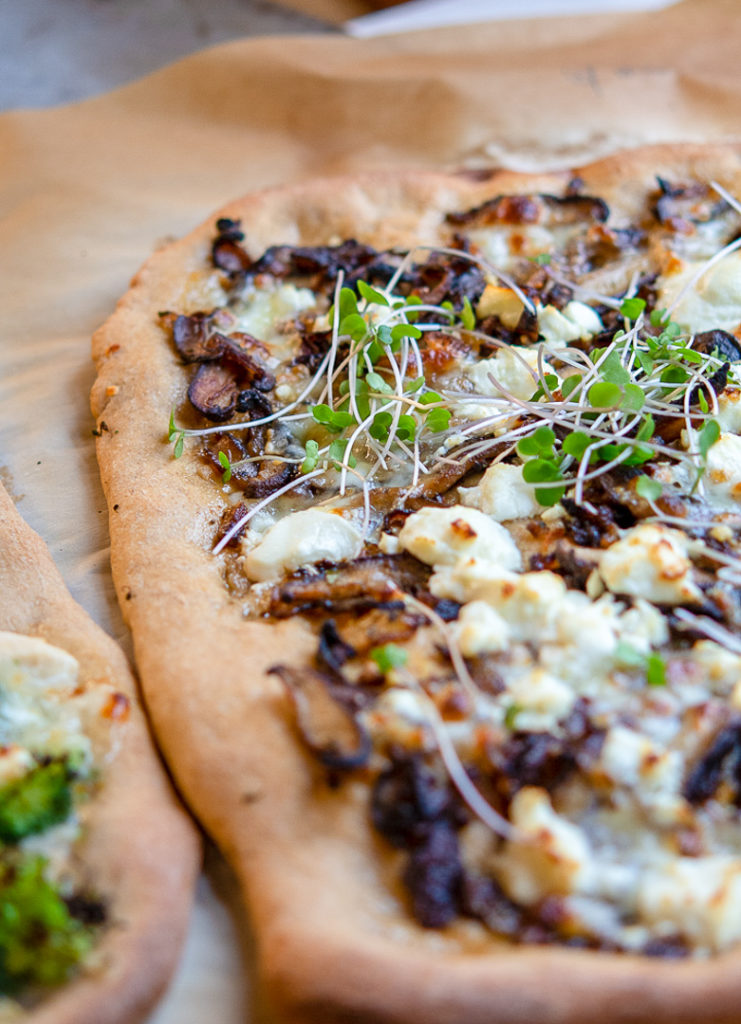 White whole wheat pizza with mushrooms and goats cheese