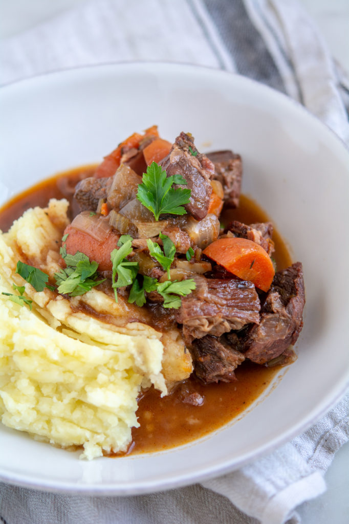 Guinness Beef Stew with mashed potatoes in a bowl