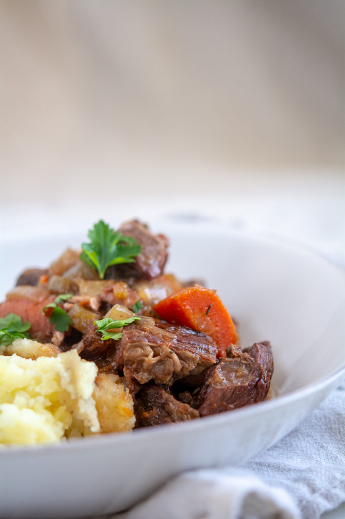 Guinness Beef Stew with mashed potatoes in a bowl