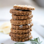 photo of rosemary oat crackers stacked on a white platter