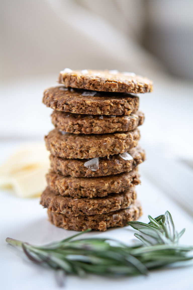 photo of rosemary oat crackers stacked on a white platter