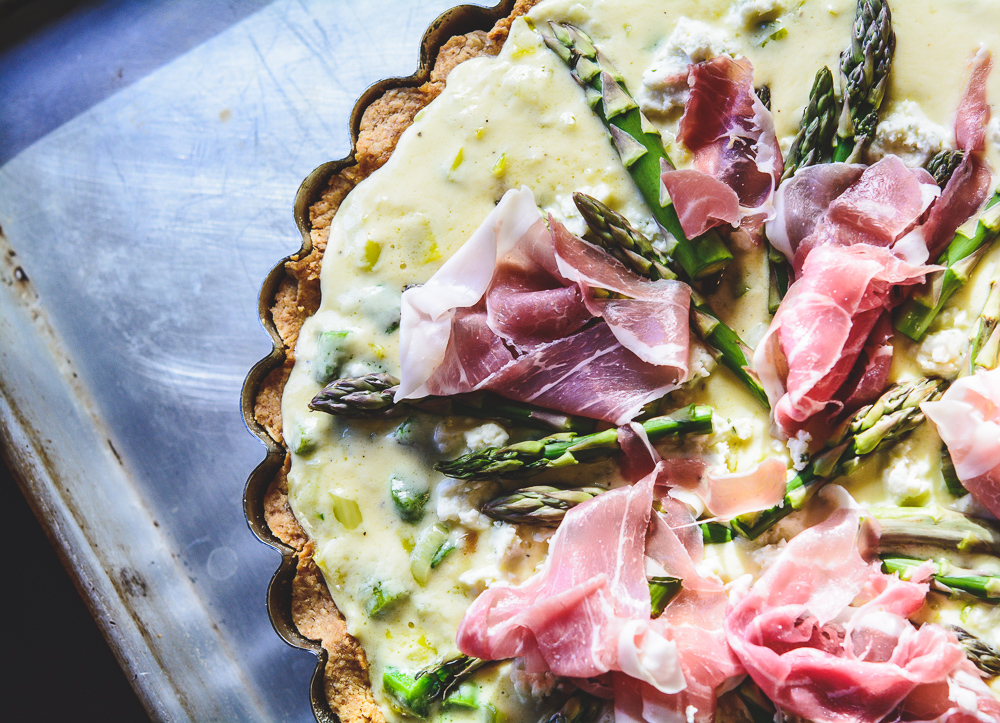 quiche filling and prosciutto in tart pan, ready for the oven