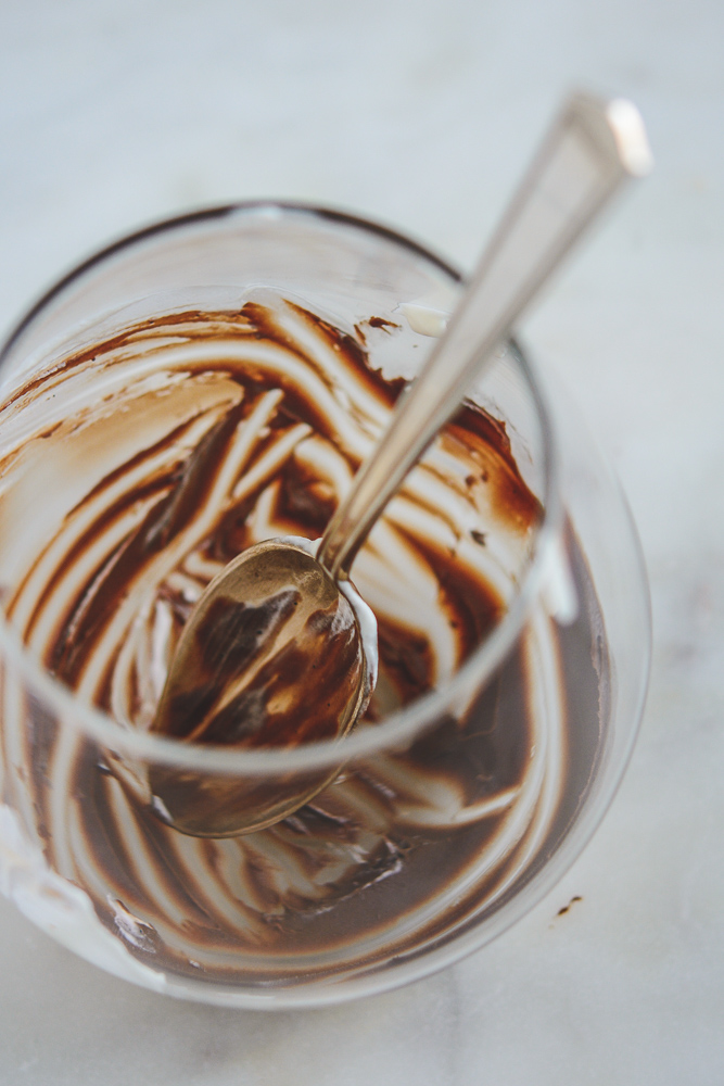 Chocolate Mexican Pots de Creme in an empty stemless wineglass with spoon