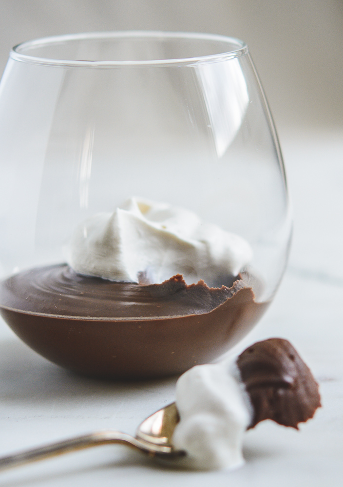 Chocolate Mexican Pots de Creme in astemless wineglass with a spoon of the yumminess