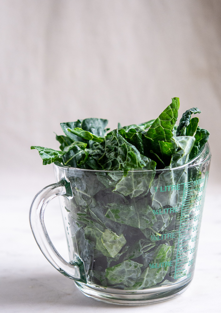 dinosaur kale in a measuring cup