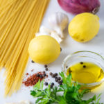 ingredients for pasta al limone: pasta, shallot, lemon, Aleppo pepper, olive oil, garlic, parmesan cheese and parsely