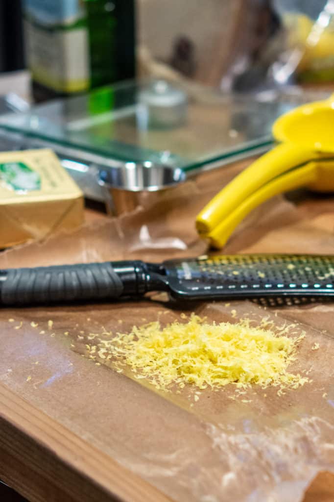 Lemon zest and microplane zester on the countertop. 