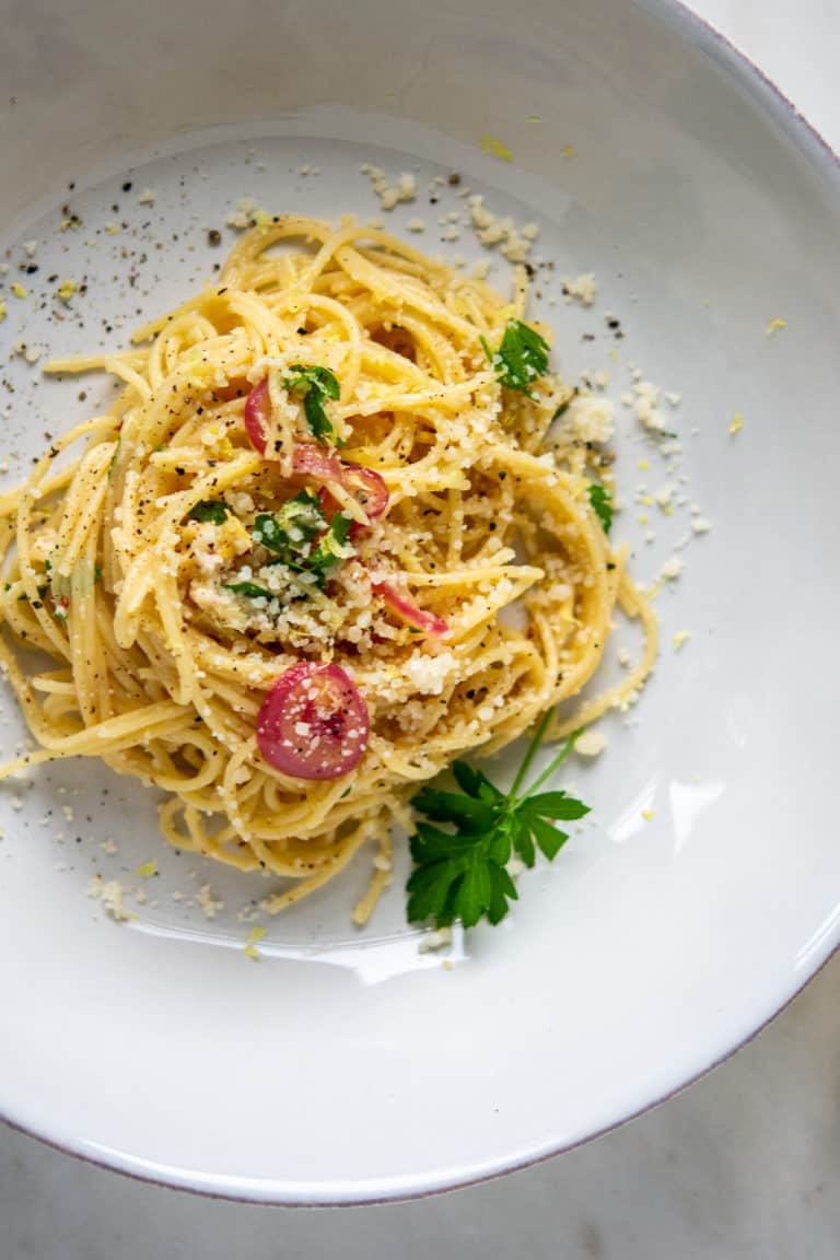 overhead shot of lemon pasta in a bowl, garnished with parsley