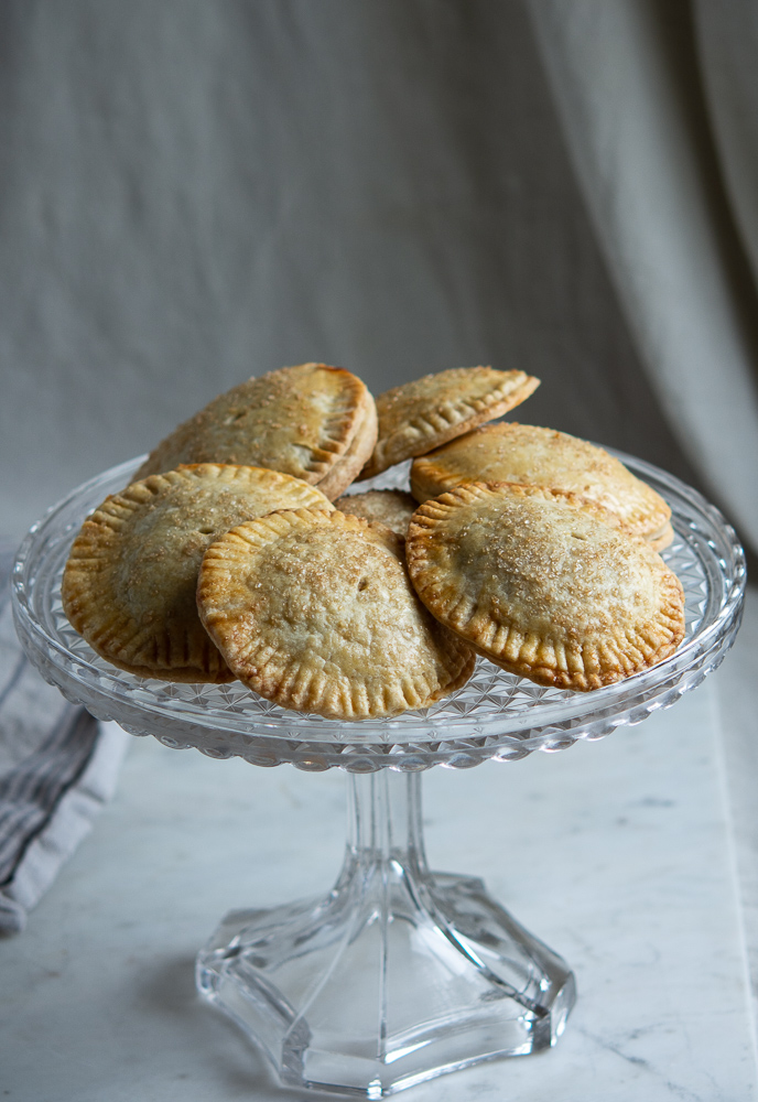 Pumpkin Hand Pies full shot on fancy glass cake plate