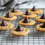 Close up of Almond Butter Bloosom Cookie photo on a baking rack with dishcloth