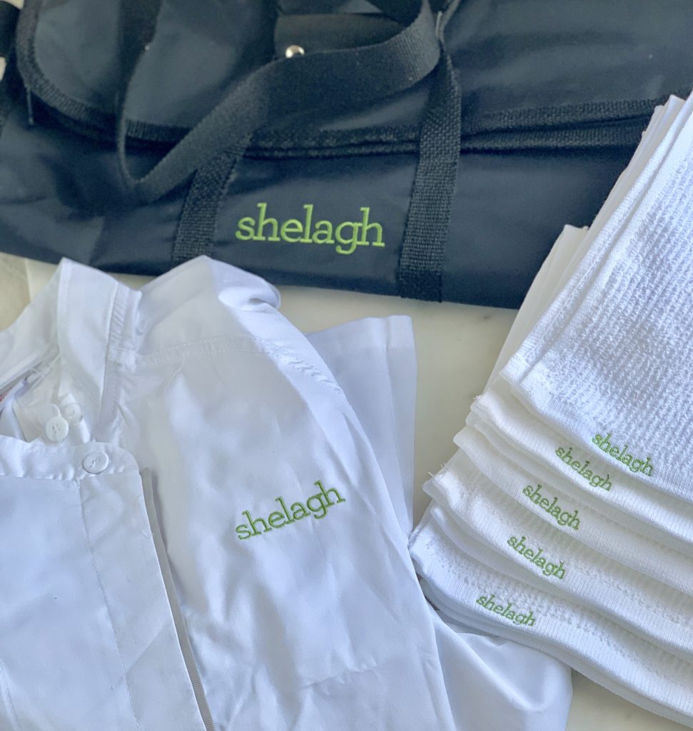 photo of monogrammed chef coat, towels and knife kit