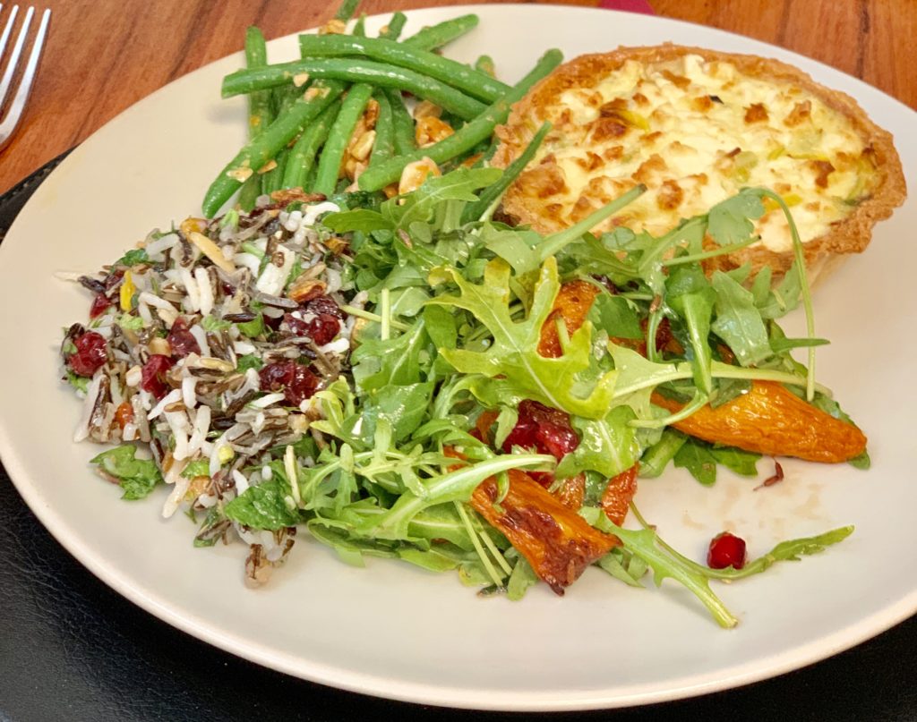 quiche, beans, carrot salad, wild rice and pomegranate salad