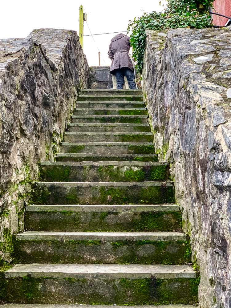 guy at the top of some cool old stairs