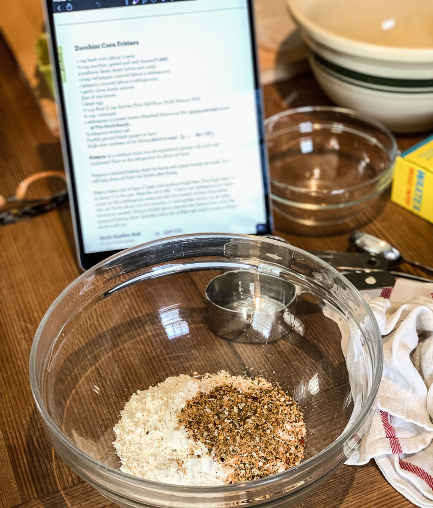 ingredients for photo of corn zucchini fritters in a bowl with ipad recipe