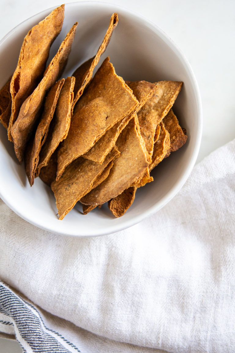 Rustic sourdough crackers lined up in a bowl