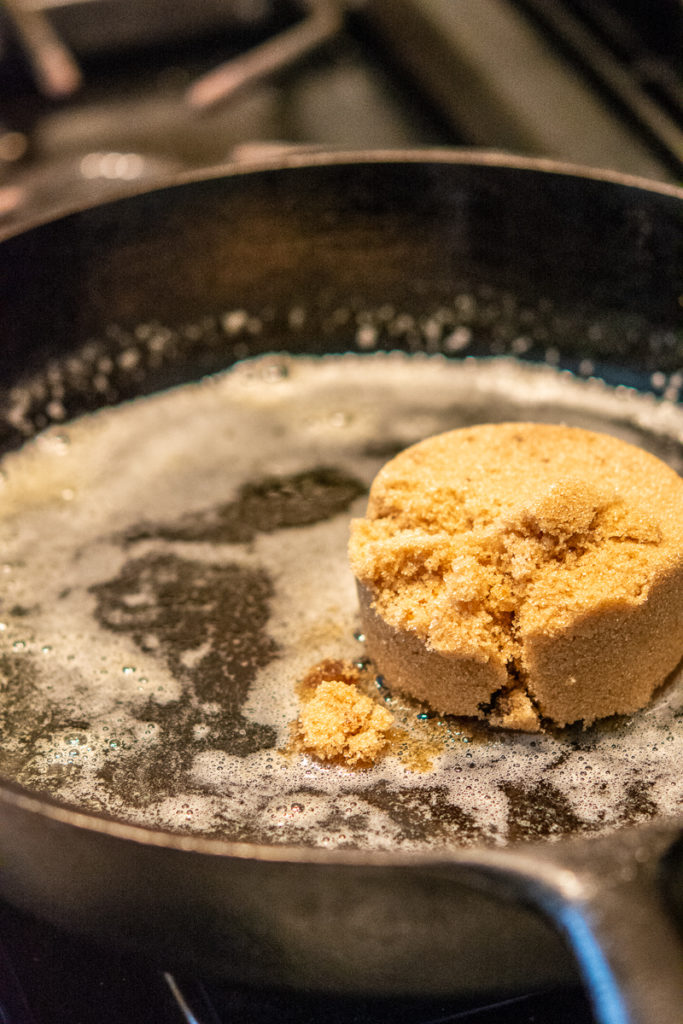 Pineapple Upside-Down Cake cast iron pan with butter and brown sugar