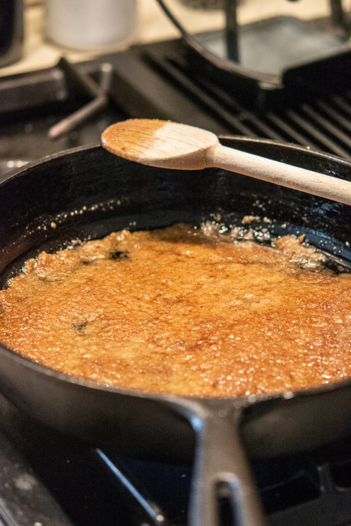 Pineapple Upside-Down Cake cast iron pan with sugar and butter