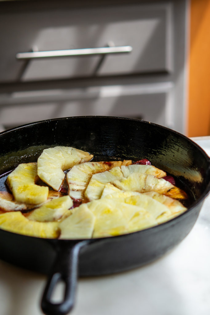 Kitchen shot of Pineapple Upside-Down Cake with pineapple, pre-bake