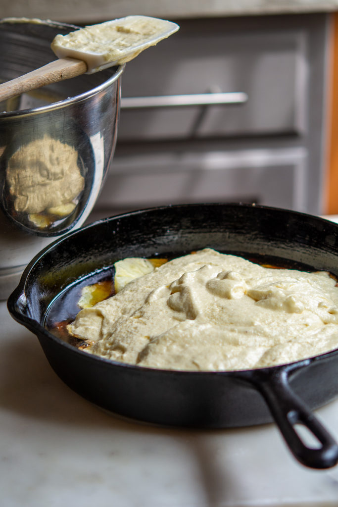 Pineapple Upside-Down Cake in cast iron pan with batter