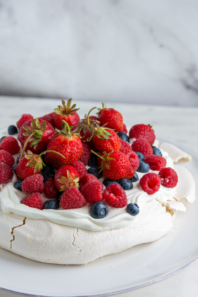 full close up shot of berry pavlova