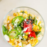 Overhead shot of Grilled Elote Corn Salad in glass dish