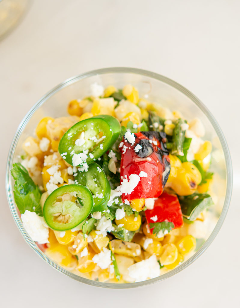 Overhead shot of Grilled Elote Corn Salad in glass dish