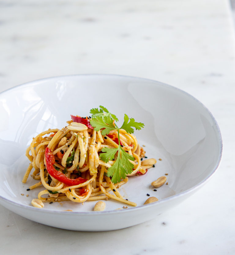 angled shot of Sesame Miso Peanut Noodles in a bowl