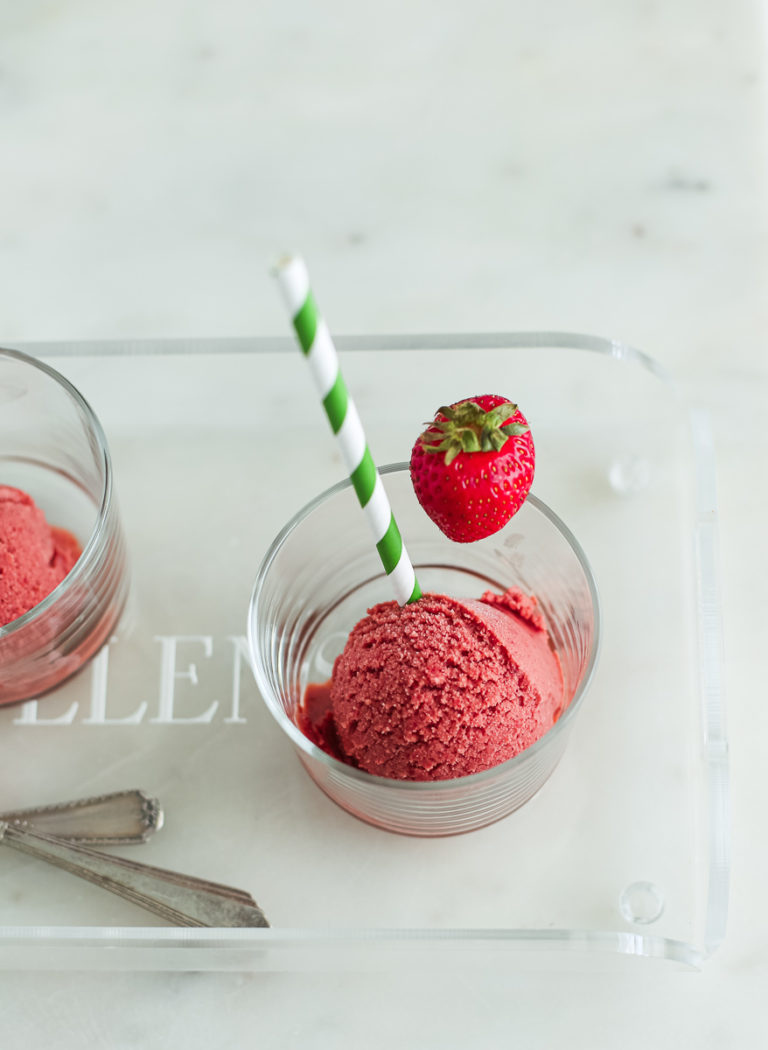 overhead shot of strawberry bang on lucite tray with straws