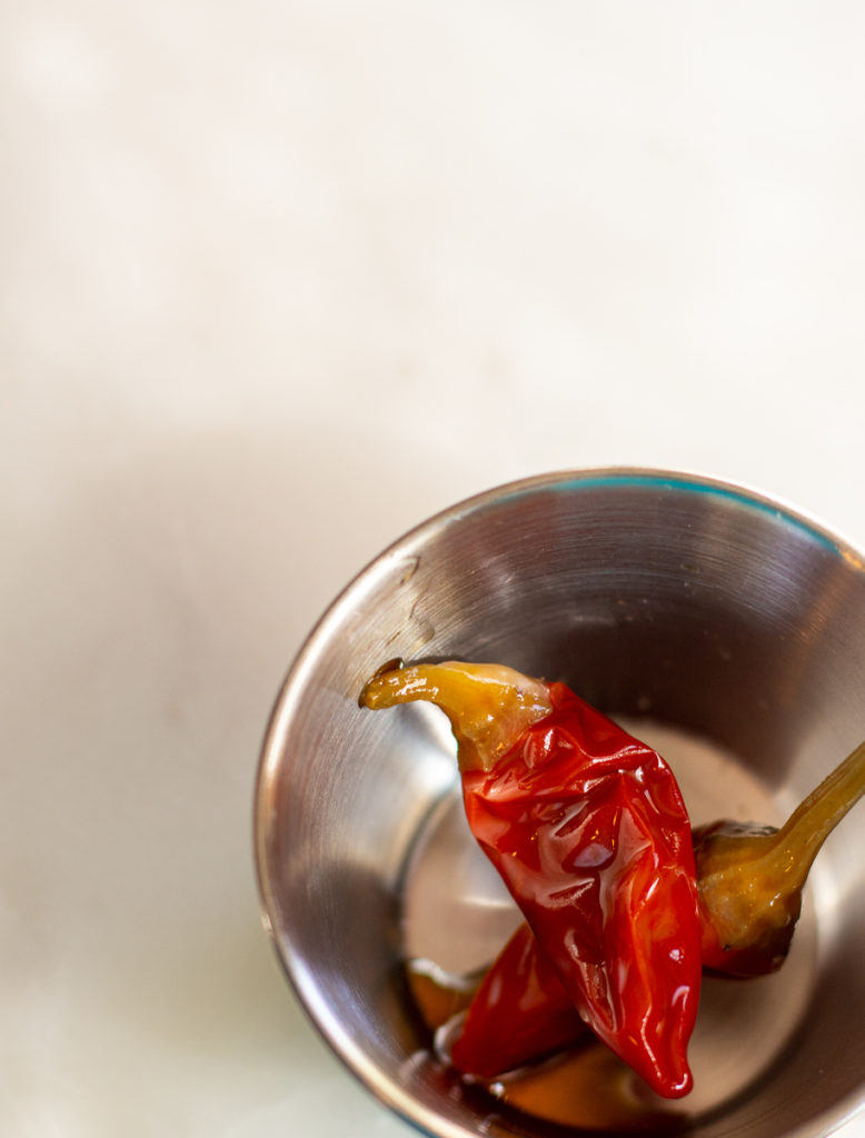 overhead shot of calabrian chilies in a small dish for Grilled Gazpacho