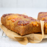 very close up shot of blood orange upside-down cake with parchment paper