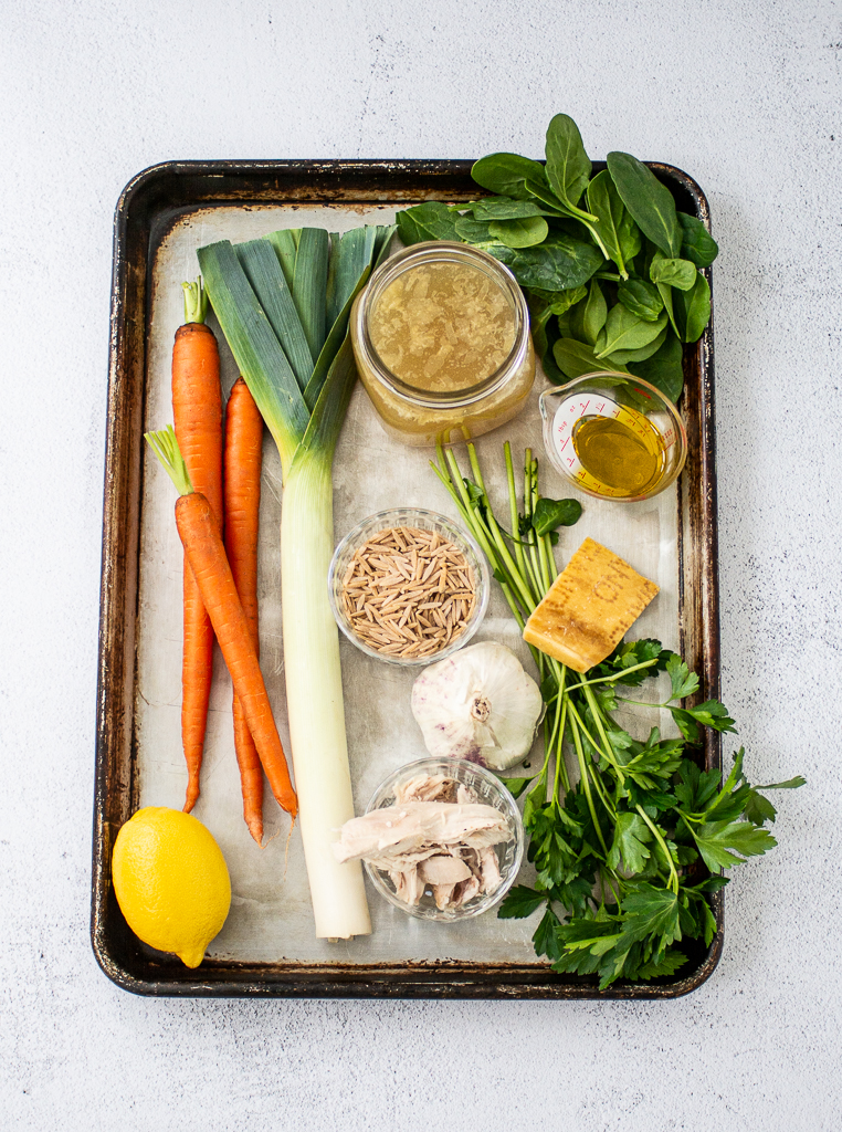 ingredients for chicken soup with lemon and orzo on a sheet pan