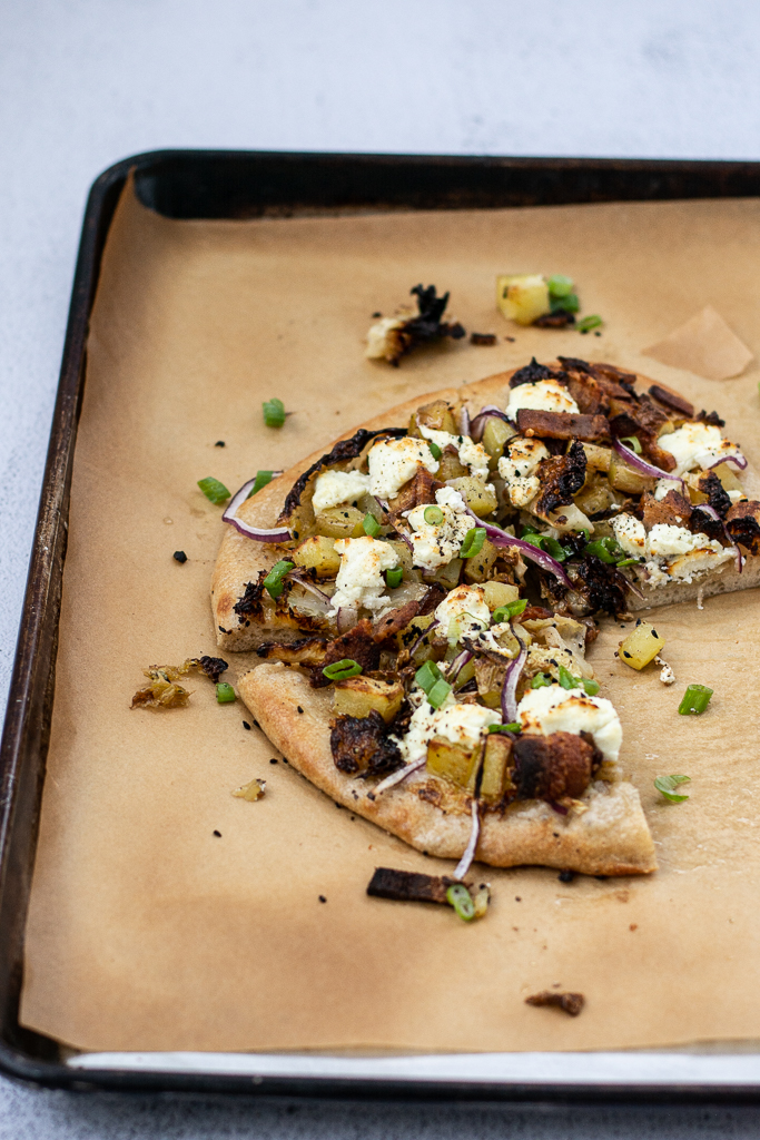 Shelagh's Irish Pizza on a sheet pan with one slice gone