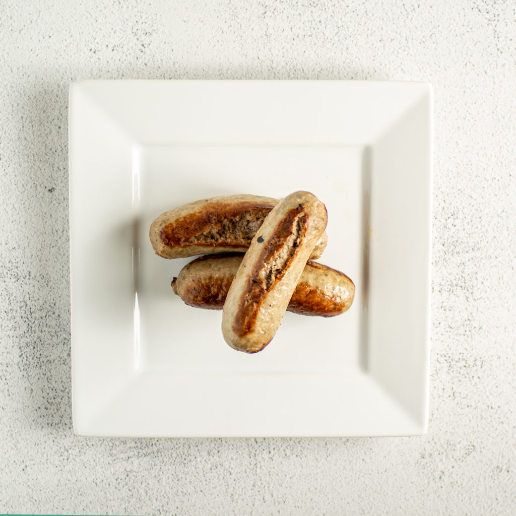 bangers on a plate for bangers and mash