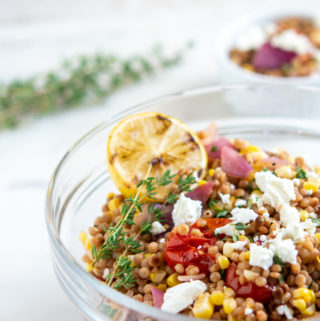 Israel Couscous Tomato and Corn Salad with Goat Cheese with lemon in the bowl