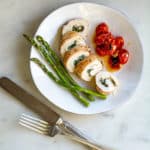 plated Goat Cheese Stuffed Chicken with Oven Roasted Tomatoes