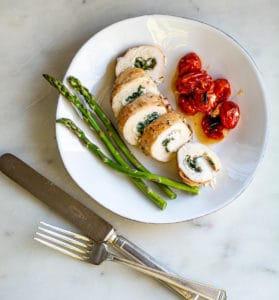 plated Goat Cheese Stuffed Chicken with Oven Roasted Tomatoes