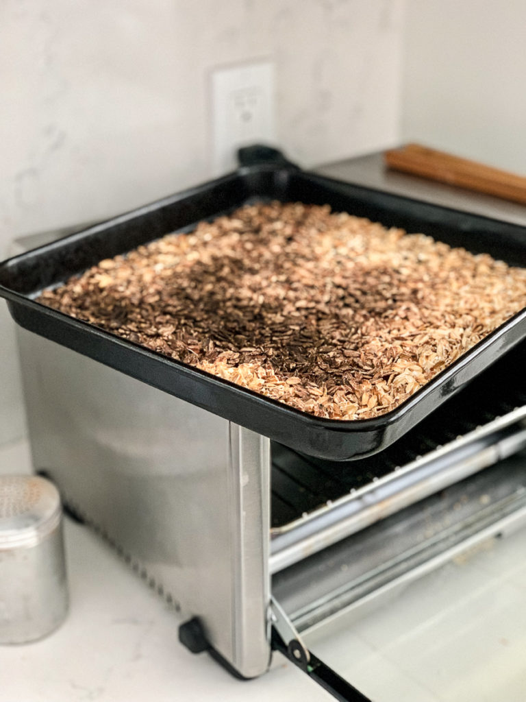 Burned oats in a black toaster oven pan