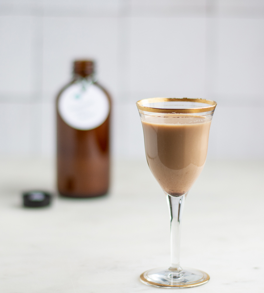 Glass of Homemade Irish Cream with bottle in background