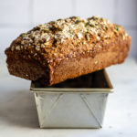 Straight on shot of Seedy Irish Brown Bread cooling on bread pan