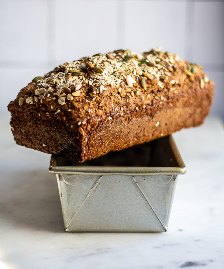 Straight on shot of Seedy Irish Brown Bread cooling on bread pan