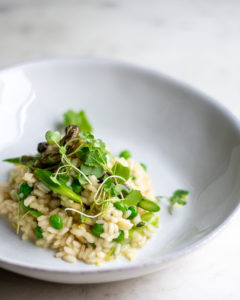 shot of spring risotto in a shallow dish