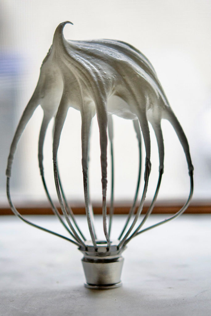whipped eggs white on a whisk