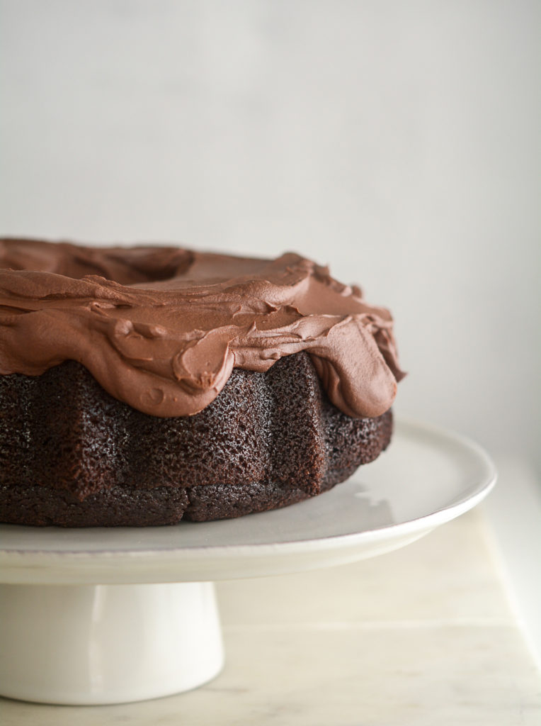 Hero shot of Guinness Chocolate Cake with Irish Whiskey Frosting on a cake stand