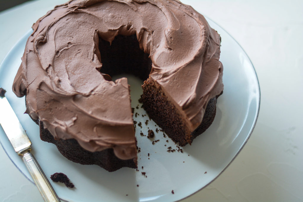 Guinness Chocolate Cake with Ganache Whiskey Frosting with a slice taken out of it
