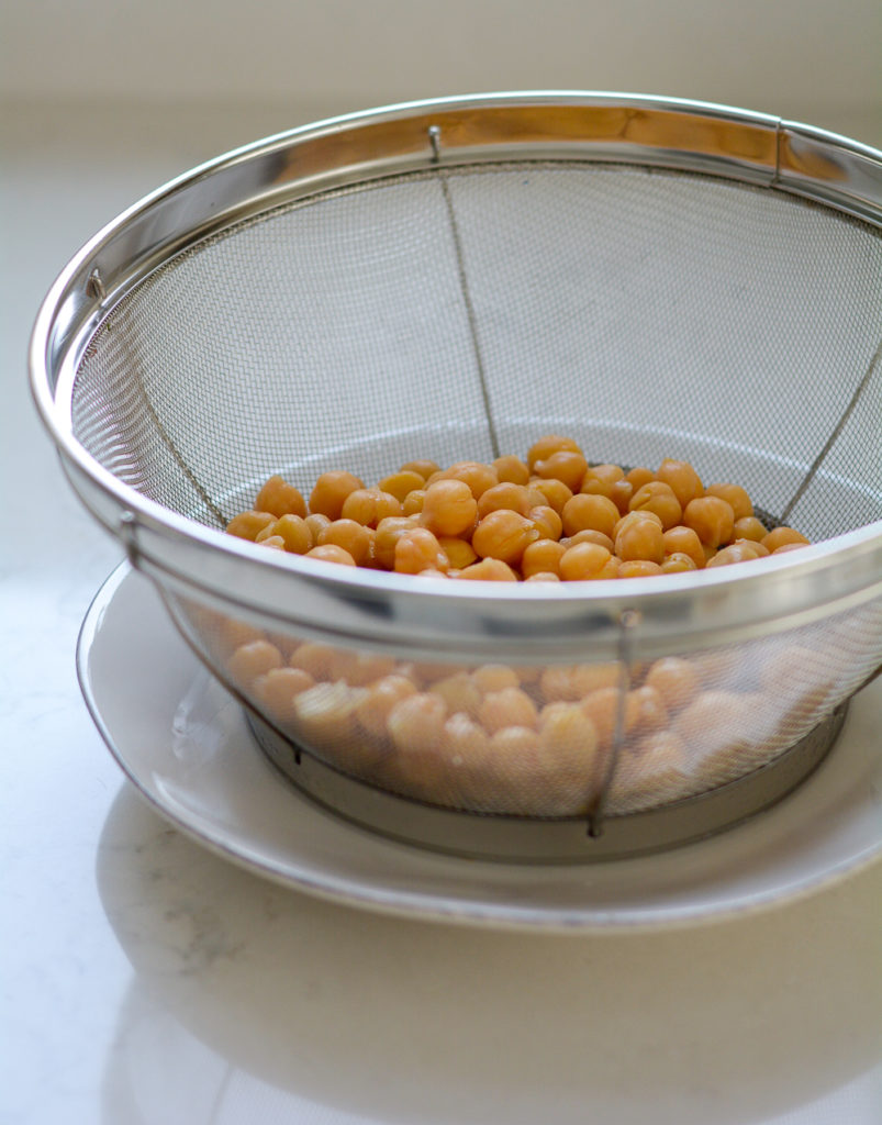 Canned chickpeas in a colander, ready for roasting
