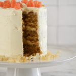 Carrot Ginger Cake with White Chocolate Cream Cheese Frosting with a slice out of it